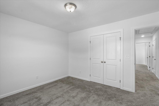 unfurnished bedroom featuring a closet and carpet flooring