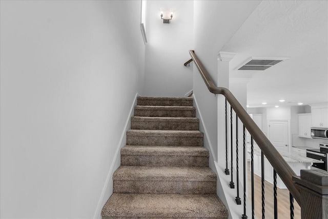 stairs featuring hardwood / wood-style floors