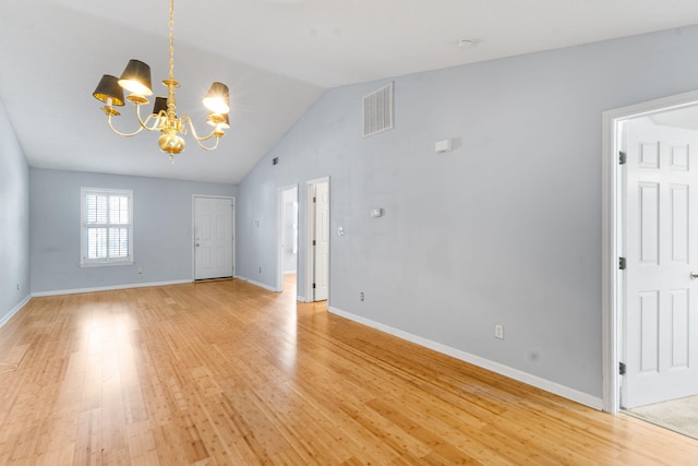 unfurnished living room with baseboards, visible vents, lofted ceiling, a notable chandelier, and light wood finished floors