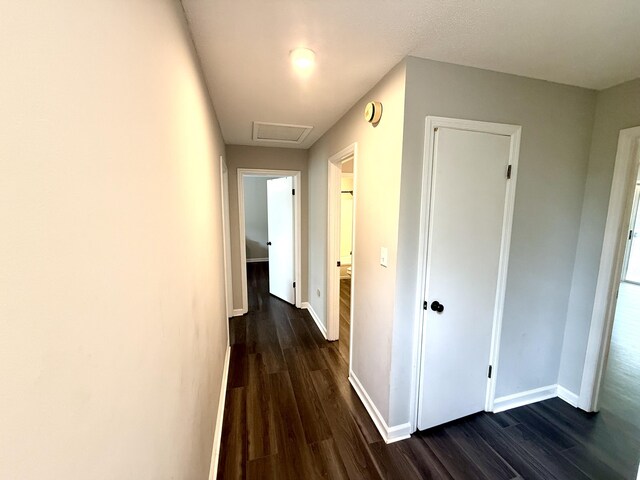 231 Norma Ln, Evans, GA 30809 - hall with dark wood-type flooring, baseboards, and attic access