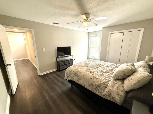 231 Norma Ln, Evans, GA 30809 - bedroom featuring baseboards, dark wood finished floors, a textured ceiling, a closet, and ceiling fan