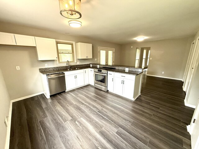 231 Norma Ln, Evans, GA 30809 - kitchen with stainless steel appliances, a sink, baseboards, a peninsula, and white cabinets
