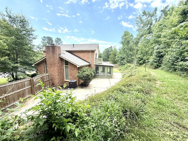 231 Norma Ln, Evans, GA 30809 - rear view of property with cooling unit, brick siding, a chimney, and a patio