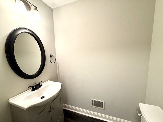 231 Norma Ln, Evans, GA 30809 - bathroom with vanity, baseboards, toilet, and wood finished floors