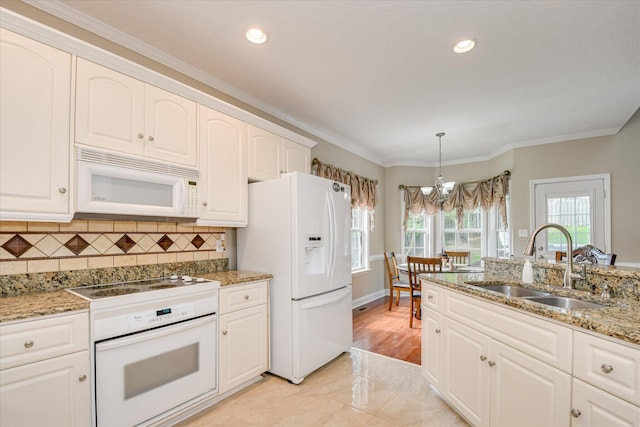 322 Farmington Dr, Evans, GA 30809 - kitchen with white appliances, a sink, a chandelier, ornamental molding, and backsplash