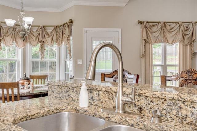 322 Farmington Dr, Evans, GA 30809 - kitchen view of a sink, a chandelier, light stone counters, ornamental molding, and decorative light fixtures