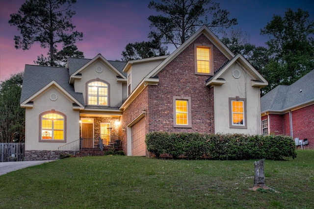 322 Farmington Dr, Evans, GA 30809 - traditional-style house with stucco siding, a lawn, an attached garage, and brick siding