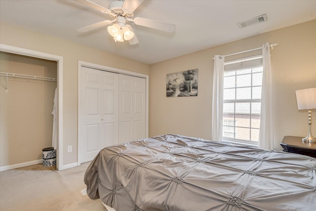 322 Farmington Dr, Evans, GA 30809 - bedroom featuring light carpet, multiple closets, a ceiling fan, and baseboards