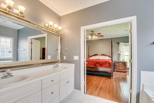 322 Farmington Dr, Evans, GA 30809 - full bathroom with ornamental molding, connected bathroom, a tub, double vanity, and a ceiling fan