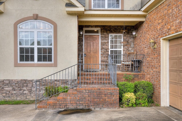 322 Farmington Dr, Evans, GA 30809 - property entrance with stucco siding, stone siding, and a garage