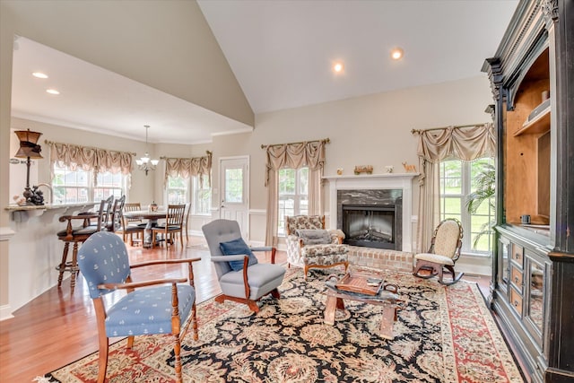 322 Farmington Dr, Evans, GA 30809 - living area featuring wood finished floors, plenty of natural light, a fireplace, vaulted ceiling, and recessed lighting