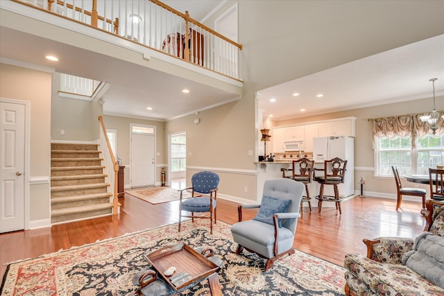 322 Farmington Dr, Evans, GA 30809 - living room with plenty of natural light, crown molding, light wood-style floors, stairway, and recessed lighting