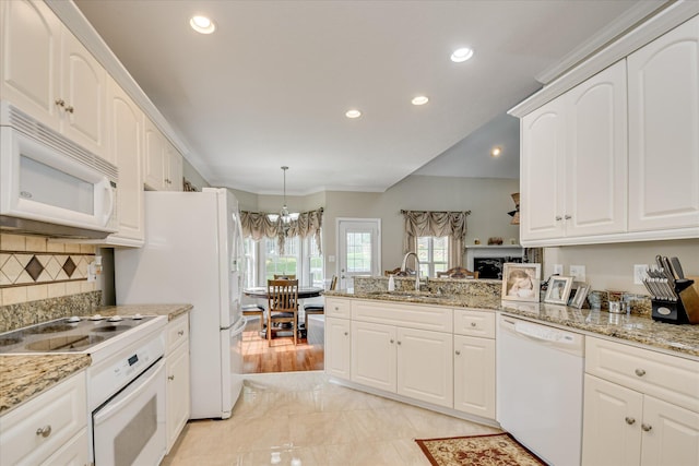 322 Farmington Dr, Evans, GA 30809 - kitchen featuring white appliances, a sink, a chandelier, a peninsula, and white cabinetry