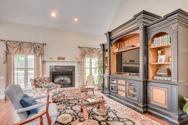 322 Farmington Dr, Evans, GA 30809 - living room featuring vaulted ceiling, plenty of natural light, a brick fireplace, wood finished floors, and recessed lighting