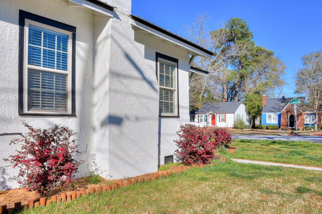 1321 Holden St, Augusta, GA 30904 - view of home's exterior with stucco siding and a yard