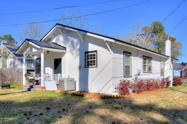 1321 Holden St, Augusta, GA 30904 - view of side of property with stucco siding, a metal roof, covered porch, and a standing seam roof