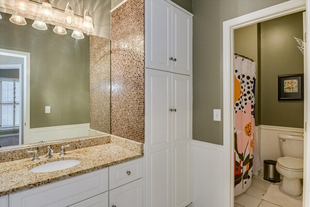 5407 Kiokee Ridge Rd, Evans, GA 30809 - full bath featuring vanity, tile patterned floors, wainscoting, and toilet