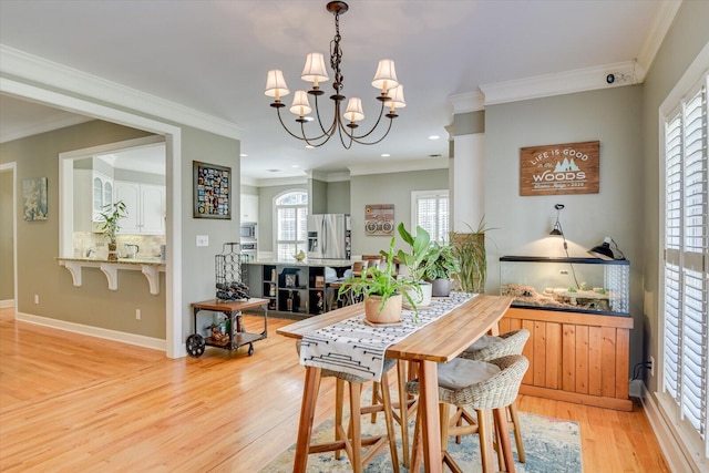 5407 Kiokee Ridge Rd, Evans, GA 30809 - dining room with a chandelier, plenty of natural light, ornamental molding, and light wood finished floors