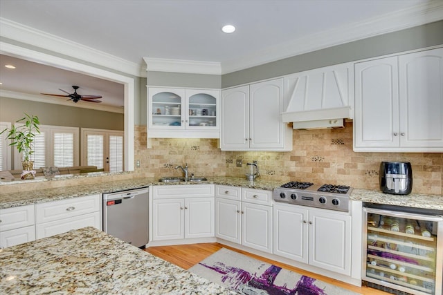 5407 Kiokee Ridge Rd, Evans, GA 30809 - kitchen featuring light stone counters, stainless steel appliances, a ceiling fan, wine cooler, and custom exhaust hood