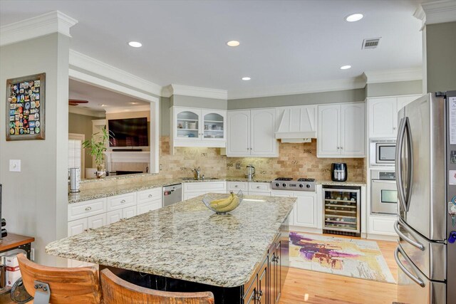 5407 Kiokee Ridge Rd, Evans, GA 30809 - kitchen featuring appliances with stainless steel finishes, a sink, premium range hood, wine cooler, and backsplash
