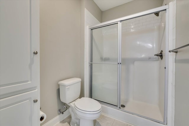 bathroom featuring walk in shower, tile patterned flooring, and toilet