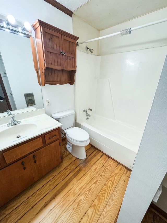 full bathroom featuring vanity, toilet, wood-type flooring, and shower / washtub combination