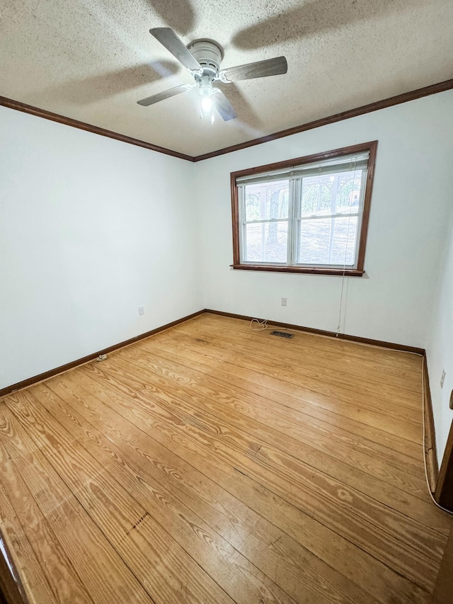 unfurnished room featuring ceiling fan, crown molding, a textured ceiling, and hardwood / wood-style flooring