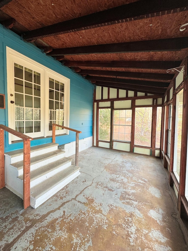 unfurnished sunroom with vaulted ceiling with beams