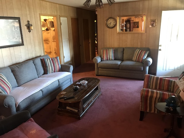 carpeted living room with wooden walls