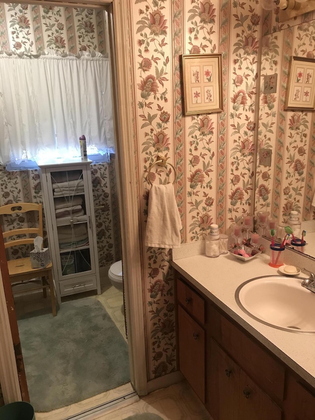 bathroom featuring vanity and toilet