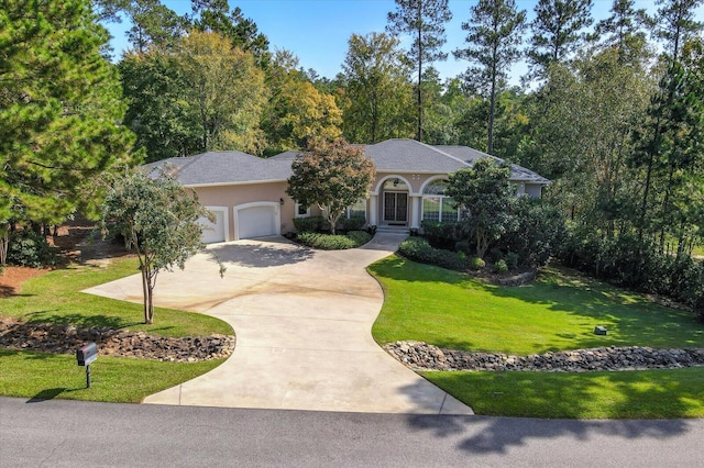 ranch-style home with a garage and a front yard