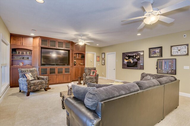 living room with light carpet and ceiling fan