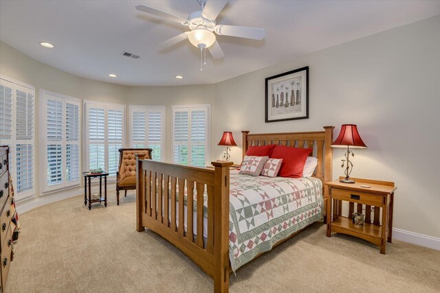 bedroom with ceiling fan and light carpet