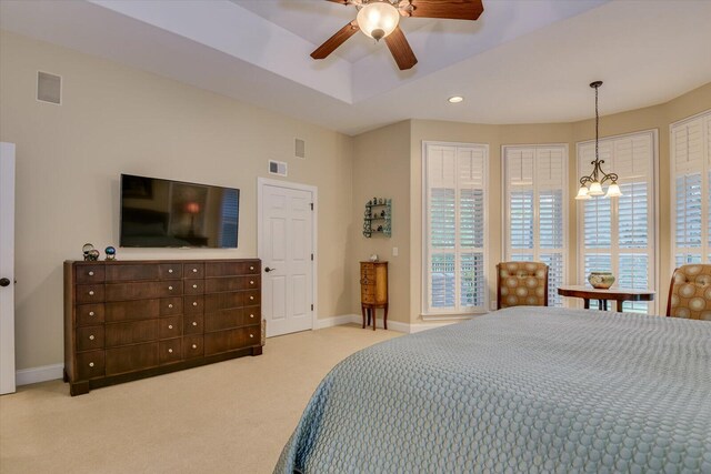 carpeted bedroom with ceiling fan with notable chandelier and multiple closets