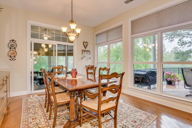 dining area with a notable chandelier and light hardwood / wood-style floors