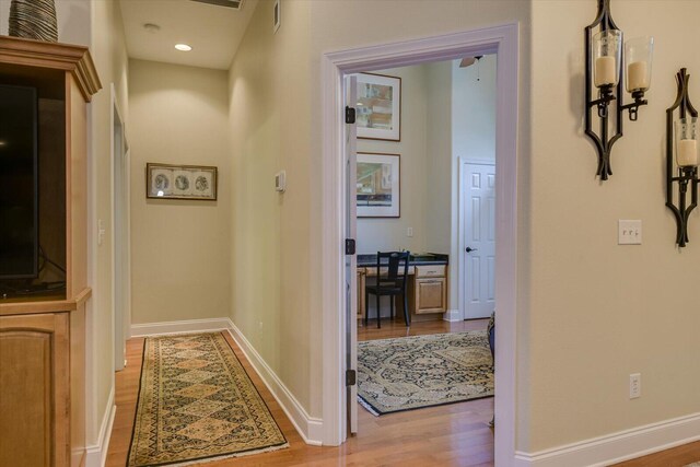 corridor with light wood-type flooring