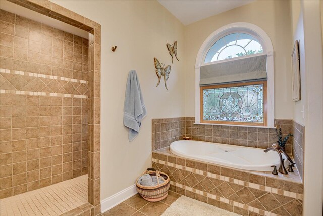 bathroom with tile patterned flooring and independent shower and bath