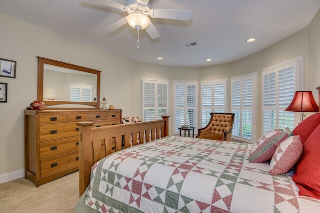 bedroom featuring light carpet and ceiling fan