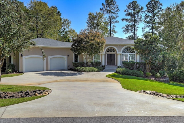 view of front of property with a front yard and a garage