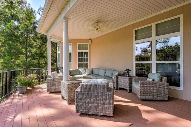 wooden terrace with outdoor lounge area and ceiling fan