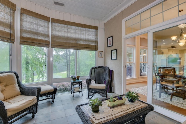 sunroom featuring ceiling fan