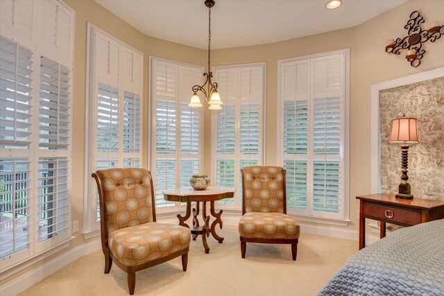 bedroom with carpet flooring, an inviting chandelier, and multiple closets