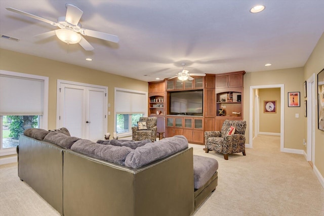 living room with light colored carpet and ceiling fan