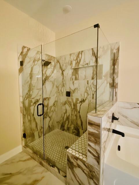 2016 Elite Ct, Hephzibah, GA 30815 - bathroom with a bath, a marble finish shower, marble finish flooring, and baseboards