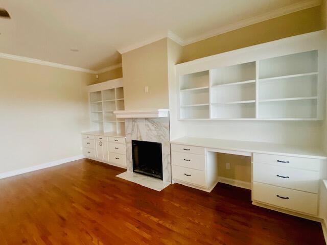 2016 Elite Ct, Hephzibah, GA 30815 - unfurnished office with crown molding, baseboards, dark wood-style flooring, a high end fireplace, and built in desk