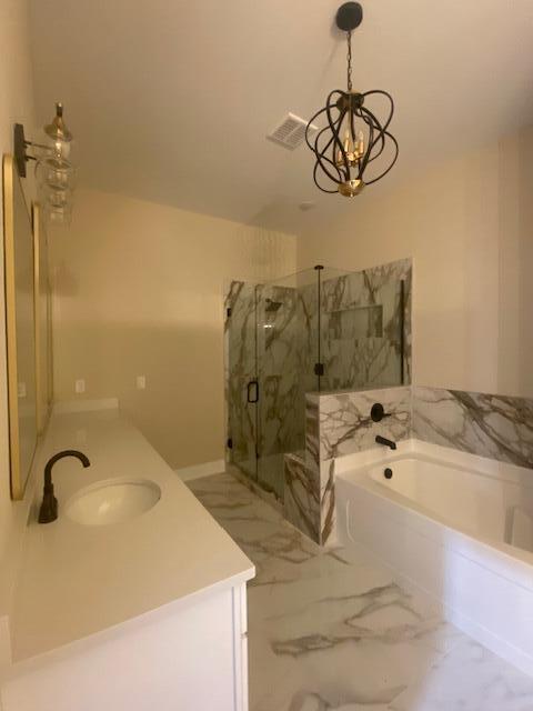2016 Elite Ct, Hephzibah, GA 30815 - bathroom featuring vanity, a garden tub, a chandelier, a marble finish shower, and marble finish flooring