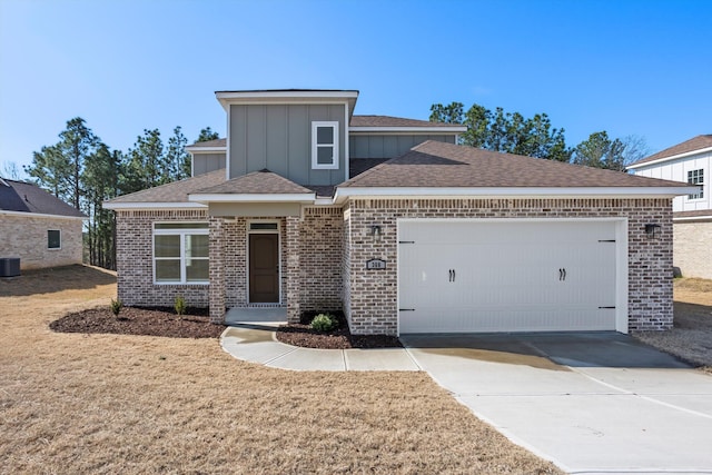 view of front facade featuring a garage, central AC unit, and a front lawn