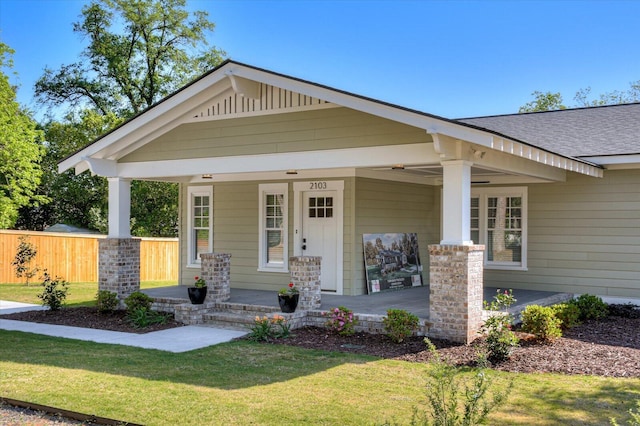 craftsman inspired home with a front yard and a porch