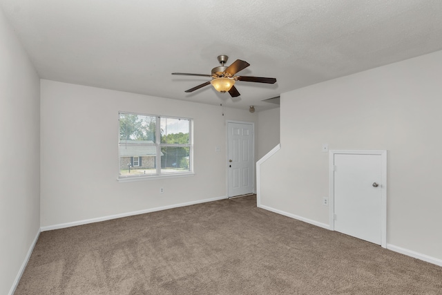 spare room with ceiling fan and carpet floors