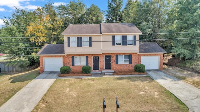 view of front of home with a front yard and a garage